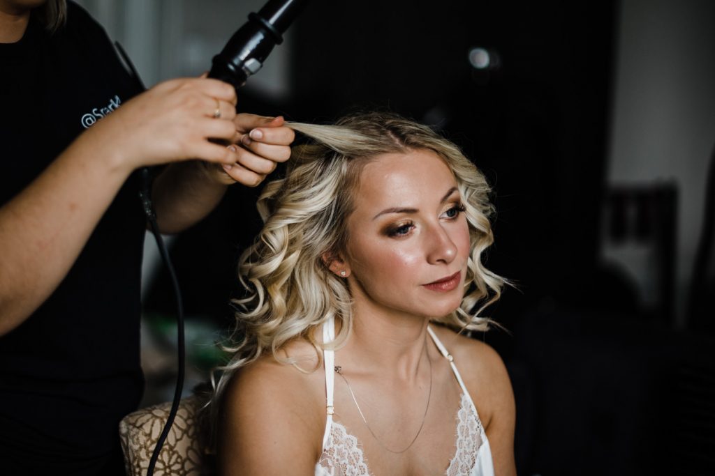 Bride has her hair curled.