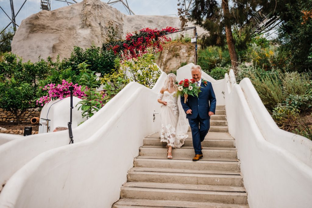 Father of the Bride walks Bride down steps