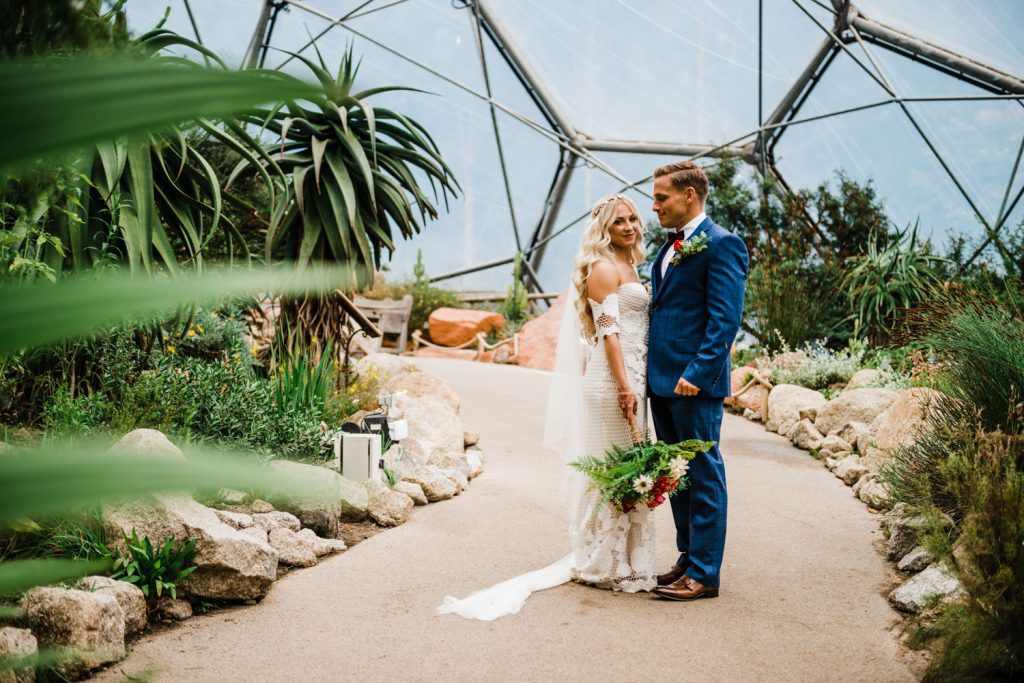 Bride and groom pose in the Eden Project
