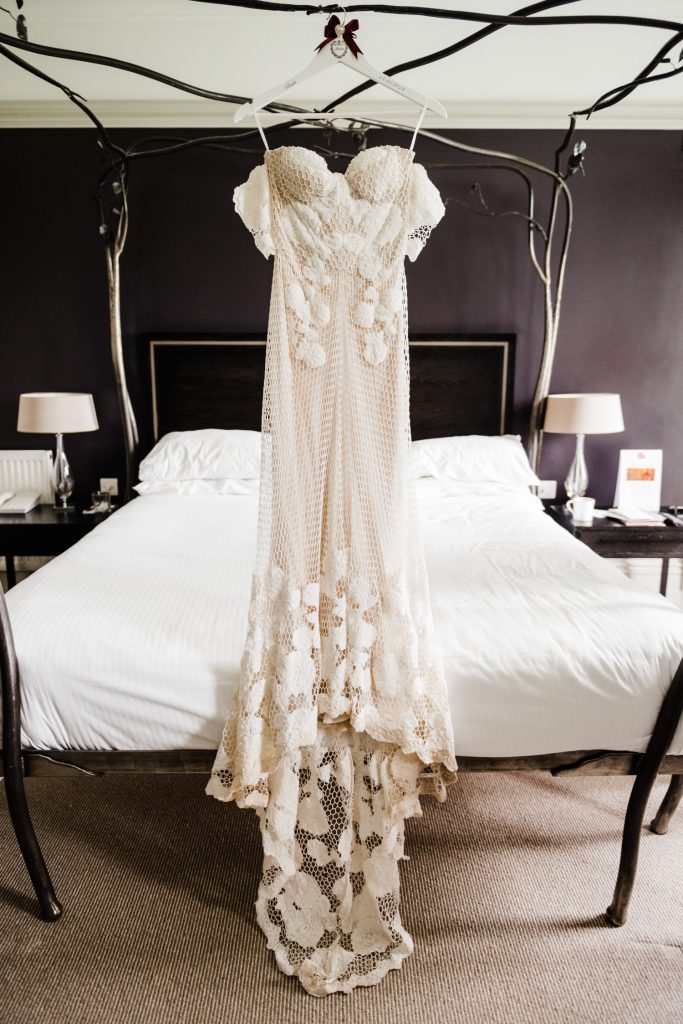 Rue de Seine bridal dress hangs from bed at the Cornwall Hotel.