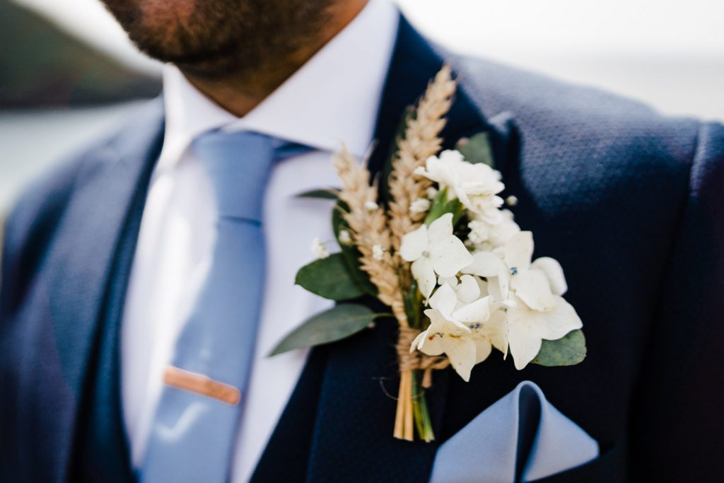 Wheat and white flower boutonniere. 
