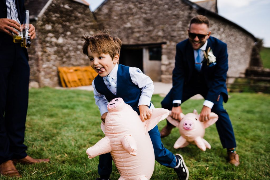 Groom races pageboy on inflatables.