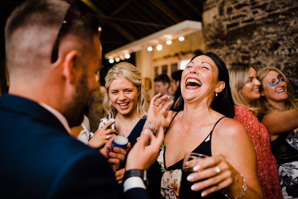 Wedding guests laughing.