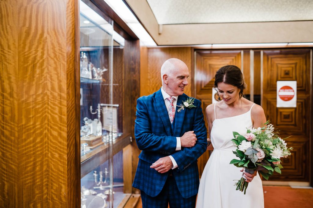 The bride takes a moment with her father outside the ceremony room at Plymouth Council House.