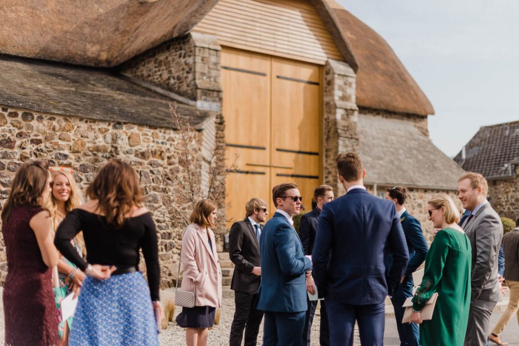 Guests mingle outside the Great Barn Devon, ahead of the wedding ceremony.