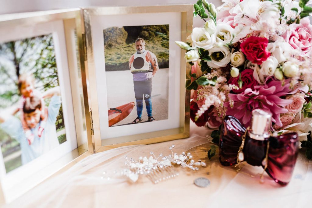 The bride's perfume and flowers are arranged next to a photograph of her late father.