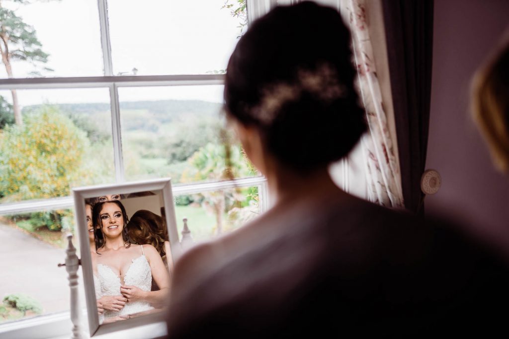 The bride looks out of the window as she prepares for the wedding ceremony.