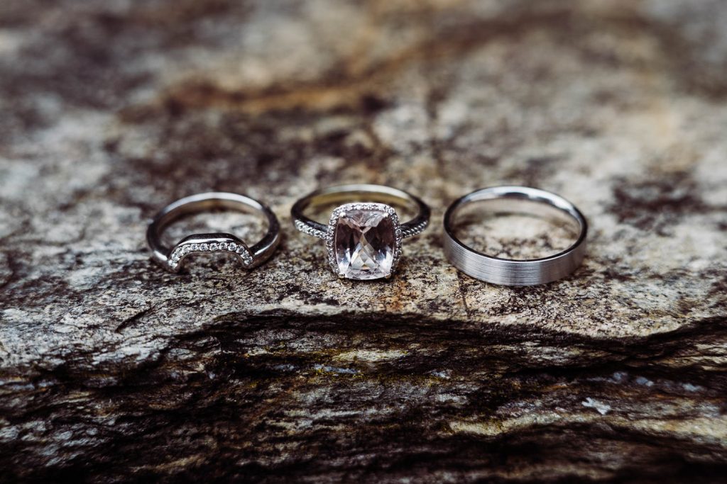 Bride and groom's wedding rings, pictured alongside the bride's engagement ring.