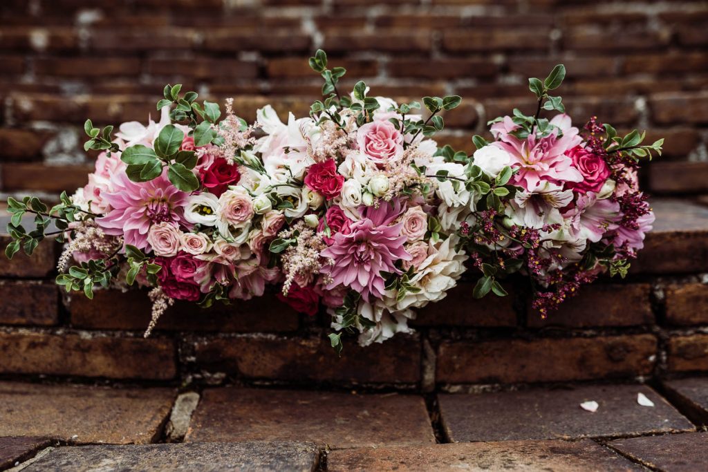 the bridal bouquet, alongside the bridesmaids' bouquets are pictured on the steps of the Horn of Plenty.