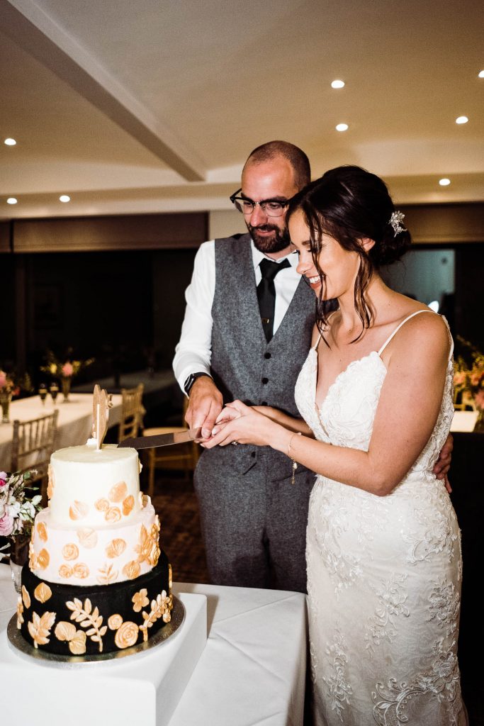 bride and groom cut their cake.