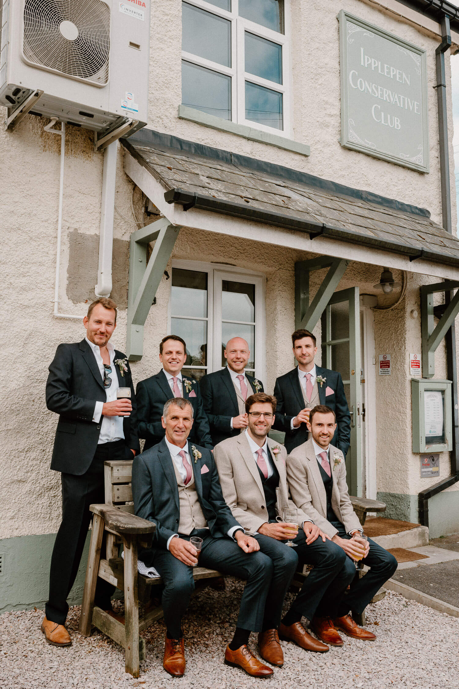 Groomsmen sitting outside Ipplepen Conservative Club enjoying a pre-wedding pint.