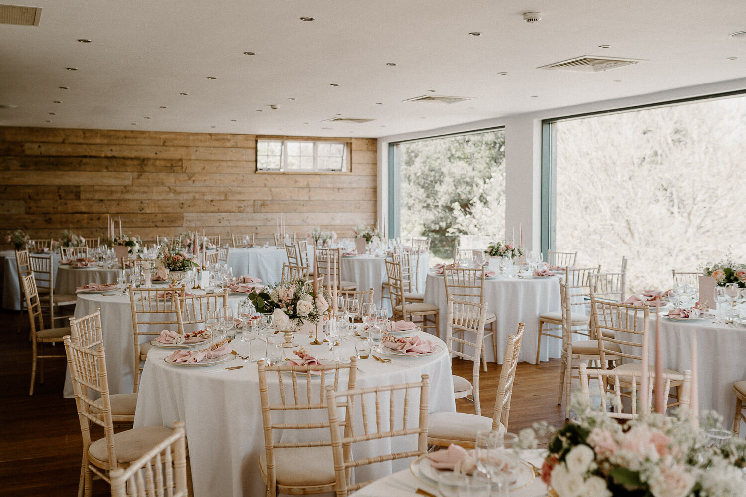 Beautifully styled reception space in a converted barn at Kingston Estate decorated in pinks and golds.