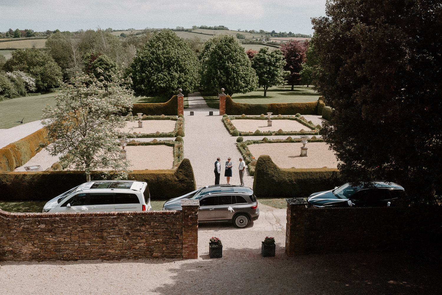 The bedroom window view at Kingston Estate where wedding cars await the bride and bridesmaids.