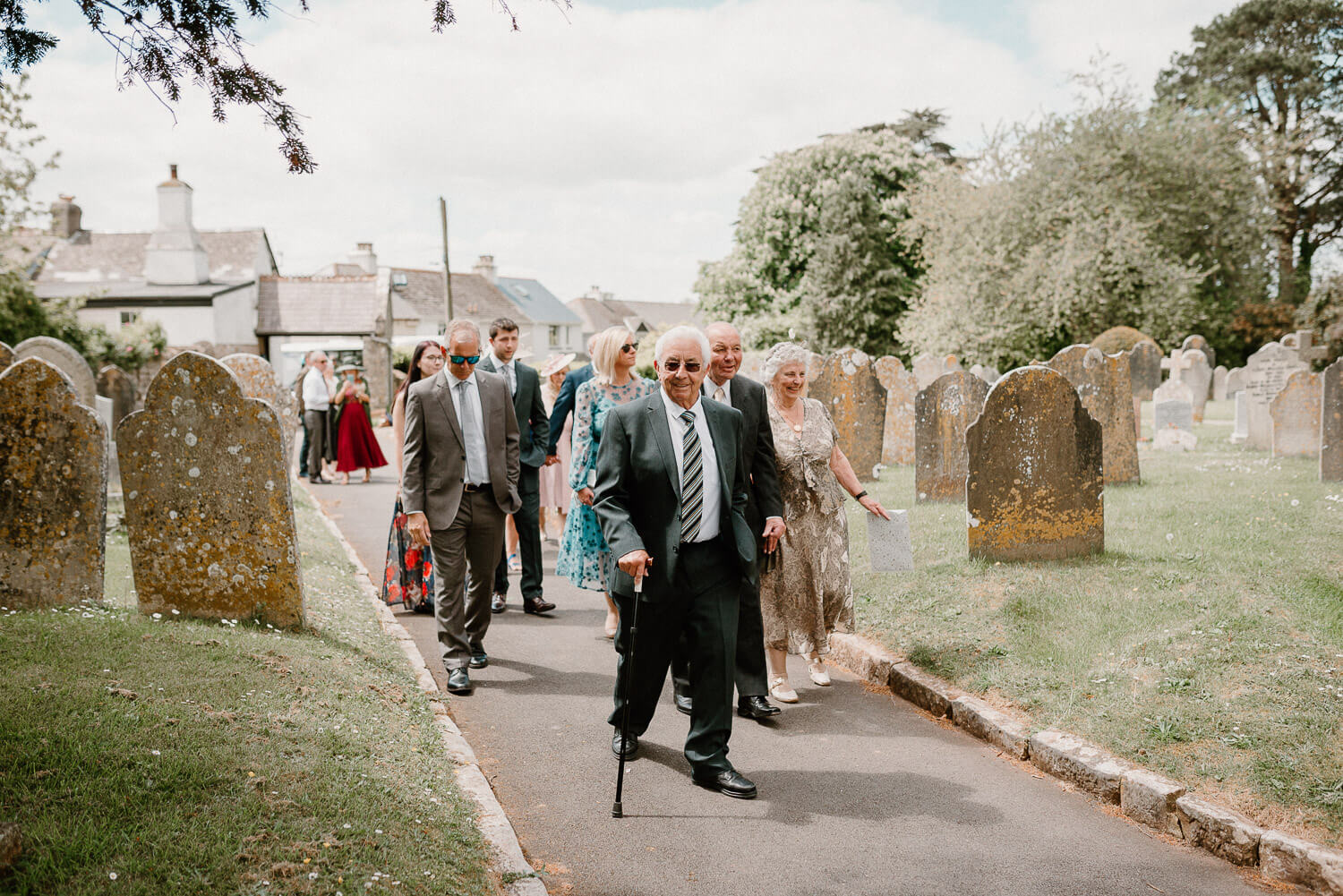 Wedding guests walk towards the church in Ipplepen, Devon.
