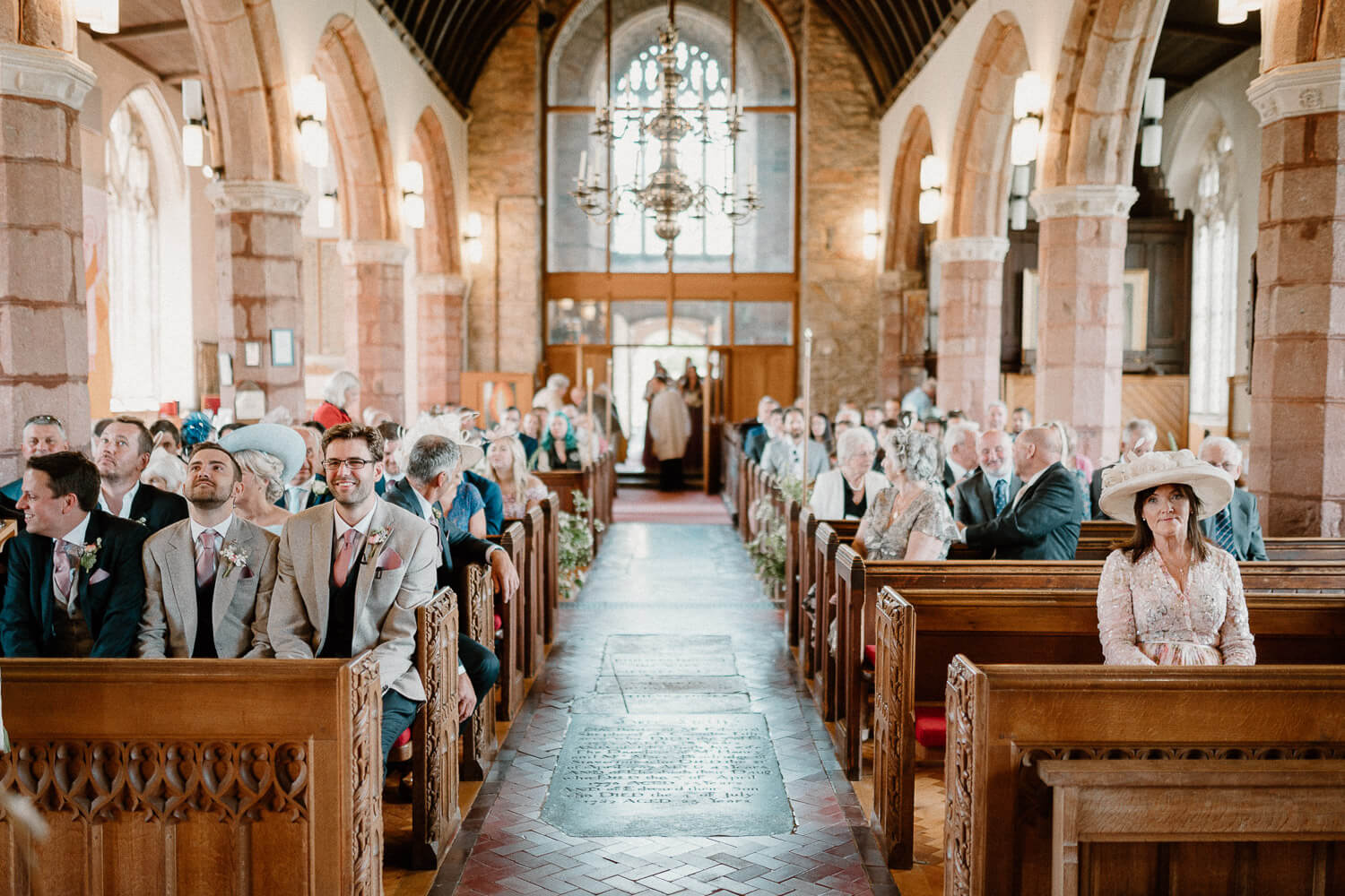Groom and guests await the brides arrival at St Andrew's Church in Ipplepen, Devon.