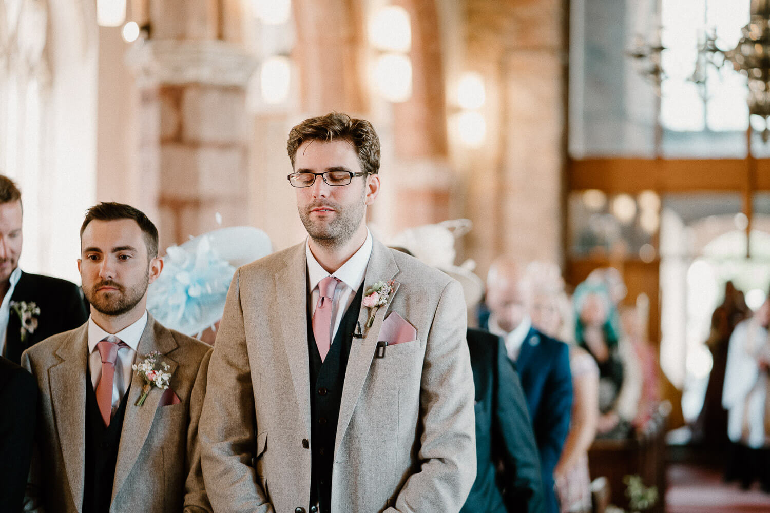Groom nervously awaits his bride at St Andrew's Church in Ipplepen, Devon.