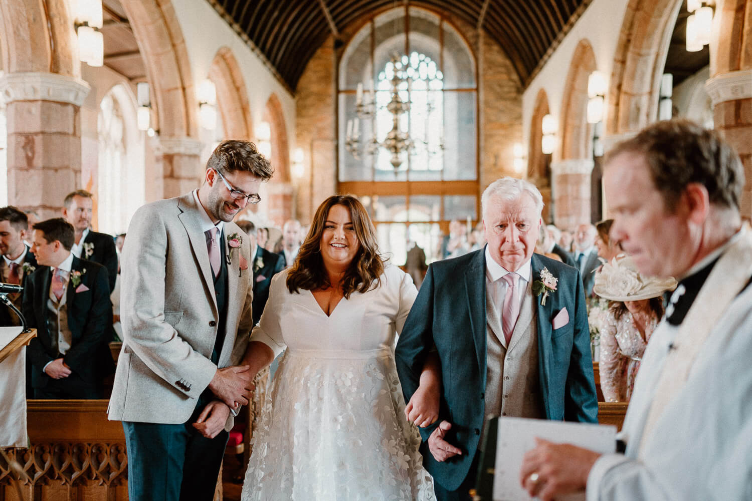Bride and groom greet one another at St Andrew's Church, Devon.