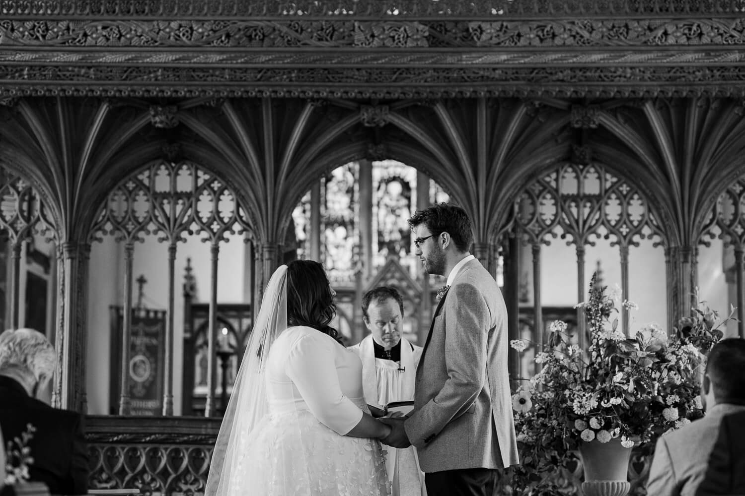 Bride and groom exchange vows at St Andrews church in Ipplepen, Devon.
