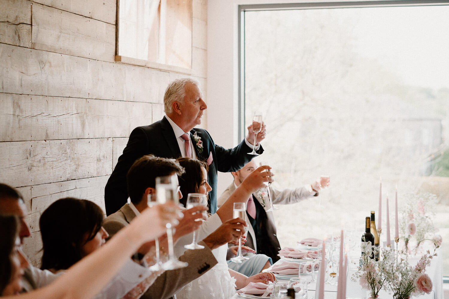 Father of the bride proposes a toast during speeches at Kingston Estate, Devon.